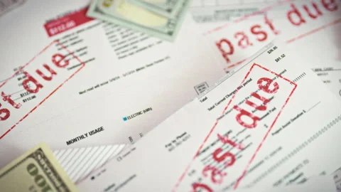 Sorting through stacks of overdue paper bills a close-up shows a utility bil Stock Footage 336570146