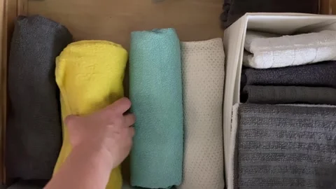 Sorting vibrant towels neatly in a drawer Stock Footage 343864124