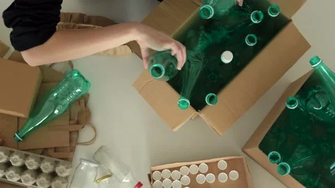 Sorting waste plastic bottles into recycling bins for recycling at home Stock Footage 196607067