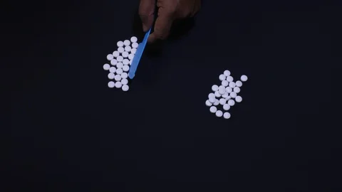 Sorting White Pills Video stock 128164870