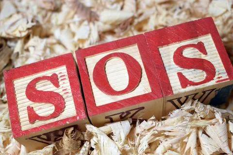 SOS morse code arranged with wooden blocks Stock Photos