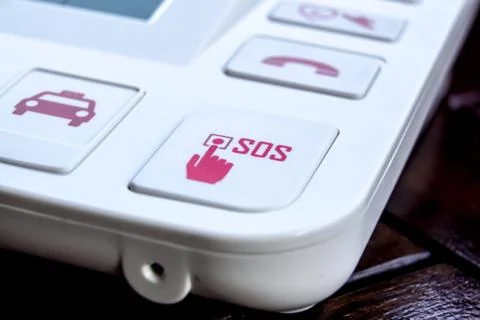 Sos Red button on a dirty old panel, selective focus Stock Photos