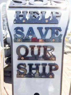 SOS save our ship sign money donation collection box Stock Photos