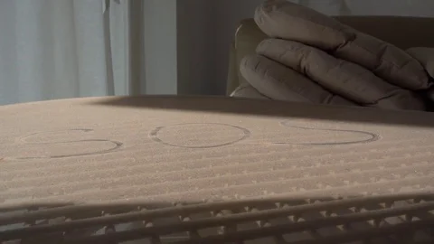SOS written by finger on dusty table Stock Footage 71162528
