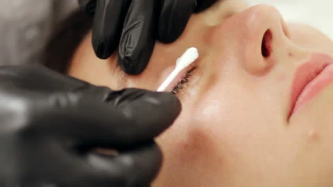 Сosmetologist cleans the eyelashes before lamination Stock Footage 219547730