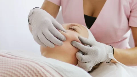 Сosmetologist makes a procedure on the cheekbones with microcurrent Stock Footage 242027471