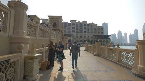The Souk Al Bahar bridge and the Burj Khalifa lake Stock-Footage 100693058