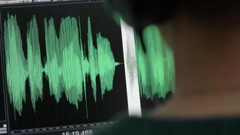 A sound editor edits an audio track on a computer. Stock Footage 263116326
