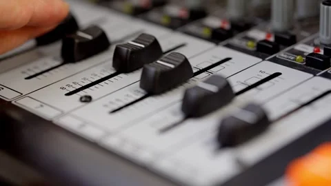 Sound Engineer Adjusting Mixer Controls in Recording Studio Stock Footage 306972338