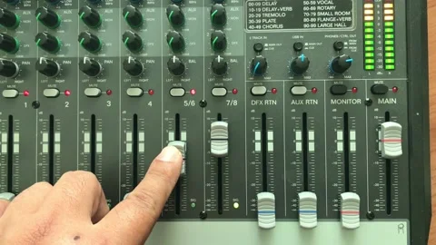 The sound engineer is adjusting the sound on the mixer. Stock Footage 149119238
