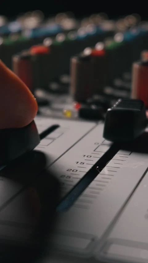 Sound Engineer Adjusting Volume Fader on Professional Audio Mixing Console Stock Footage 334739579