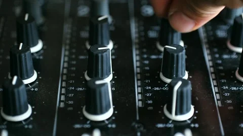Sound engineer adjusting volume knob on mixing console Video stock 318918003