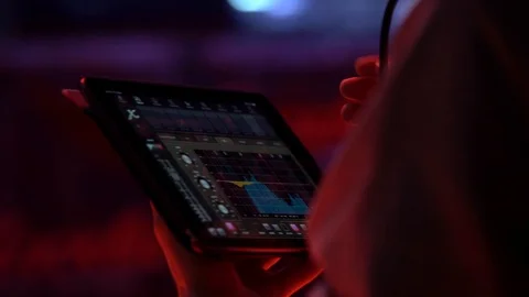 Sound engineer adjusts the sound using the application in the tablet Stock Footage 106560234