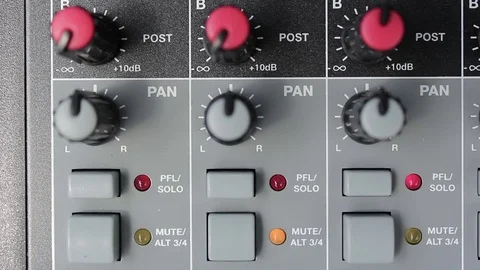 Sound engineer checking and adjusting the levels on a mixing desk 库存影片 72221352