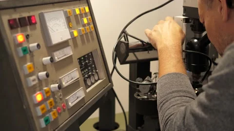 Sound engineer checking recorded music track on vinyl with a microsope Video stock 157712079