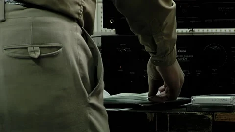 A Sound Engineer Choosing Compact Discs Stored in Sleeves in His Studio.   Stock Footage 231792873