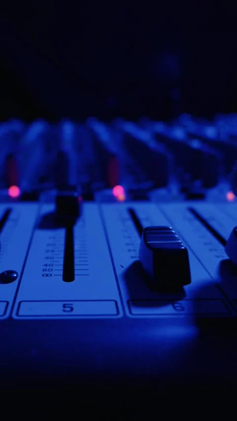 Sound Engineer Hand Adjusting Faders on Professional Audio Mixing Console Stock Footage 334738035