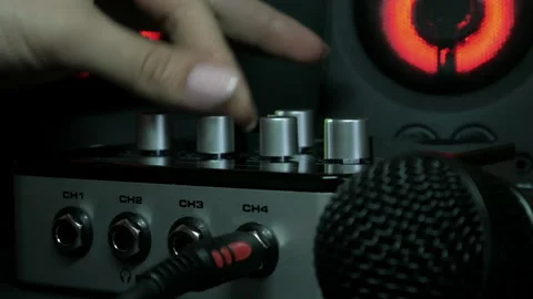 Sound engineer hands adjusting knobs and faders on audio mixer in recording Video stock 329129952