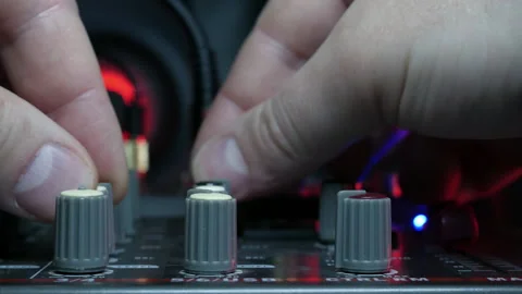 Sound engineer hands adjusting knobs and faders on audio mixer in recording 库存影片 331200497