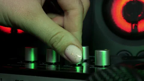 Sound engineer hands adjusting knobs and faders on audio mixer in recording. Stock Footage 334037833