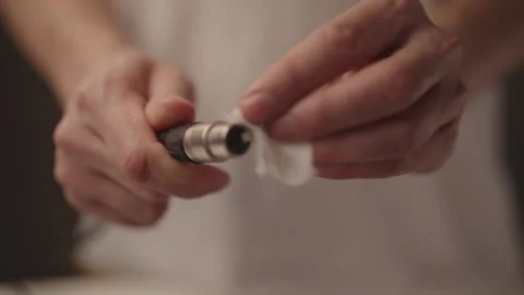 Sound engineer hands cleaning XLR audio cable connector with white cloth Stock Footage 323451484