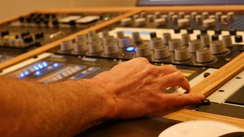 Sound engineer mixing with sliders and knobs in a professional recording studio Stock Footage 89028071