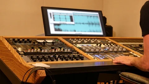 Sound engineer mixing with sliders and knobs in a professional recording studio 스톡 동영상 89028134