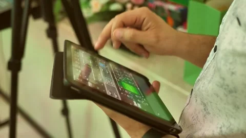 Sound engineer monitors sound via tablet app. close-up of hands. Stock Footage 295798252