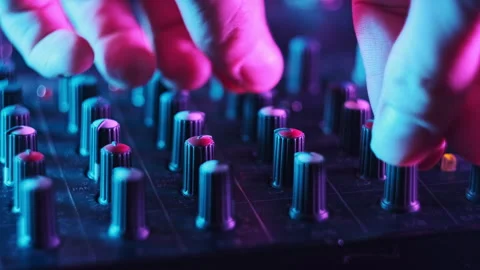 Sound Engineer Move Faders Level on Audio Mixer Console in Neon Light Close-Up Stock Footage 260222908