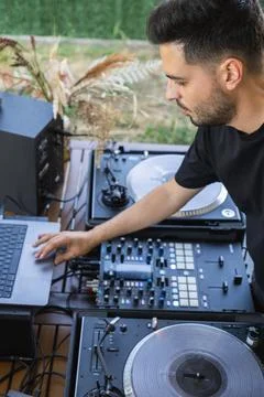 Sound engineer preparing the mixing console before the DJ session Stock Photos