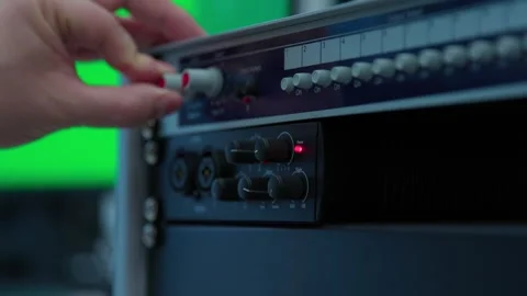 A sound engineer pushing buttons on a mixer Stock Footage 276258512