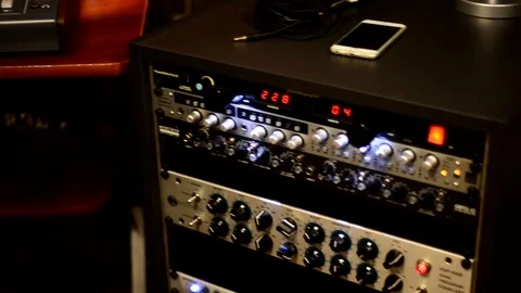 Sound engineer in recording studio using laptop at the mixing desk. Stock Footage 79669354