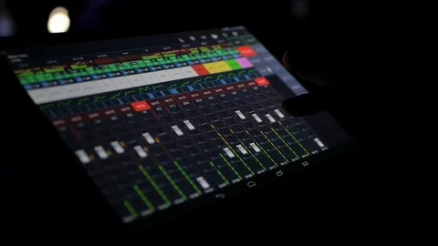 The sound engineer remotely adjusts the sound at the concert using the program Stock Footage 114250916