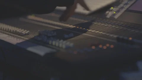Sound engineer resetting audio controls on sound desk Stock Footage 98694645