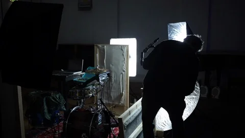 Sound engineer sets up mic for music recording Stock-Footage 98756948