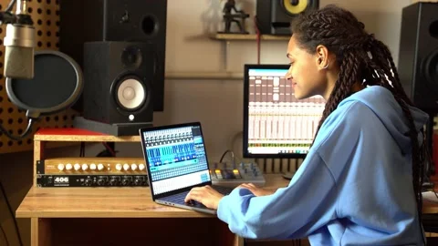 Sound engineer using control desk recording new track for album in soundproof Stock Footage 187212667