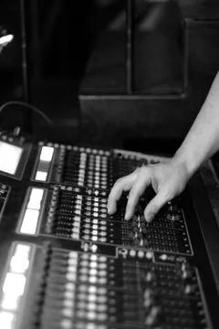 The sound engineer at work behind a mixing console at a concert Stock Photos