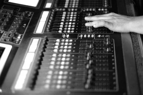 The sound engineer at work behind a mixing console at a concert Stock Photos
