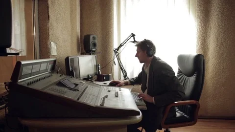 The sound engineer is working behind the remote control in the recording studio. Stock Footage 80667967
