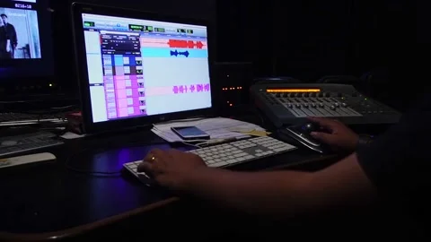 Sound engineer working in digital audio and video editing post production studio Video stock 176469440