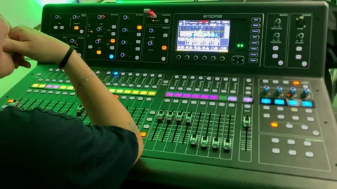 Sound engineer working on digital audio mixing console Stock Footage 334688856