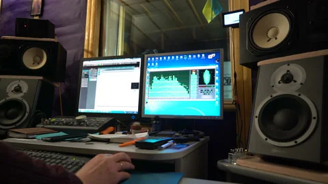 Sound engineer working at mixing panel in boutique recording studio. Close-up Stock-Footage 87285644
