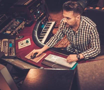 Sound engineer working at mixing panel in the boutique recording studio. 스톡 사진