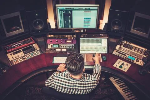 Sound engineer working at mixing panel in the boutique recording studio. Foto stock