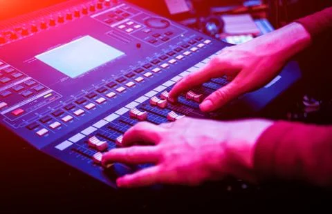 Sound engineer working at mixing panel in the in sound recording studio. Stock Photos