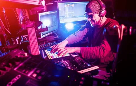 Sound engineer working at mixing panel in the in sound recording studio. Stock Photos