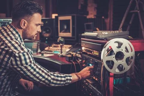 Sound engineer working with professional audio equipment in the boutique reco 스톡 사진