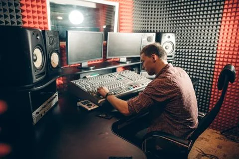 Sound engineer at workplace. side view shot. pleasant sound operator at work Stock Photos