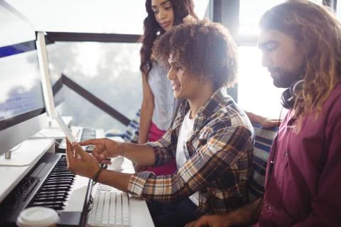 Sound engineers using digital tablet while working Stock Photos