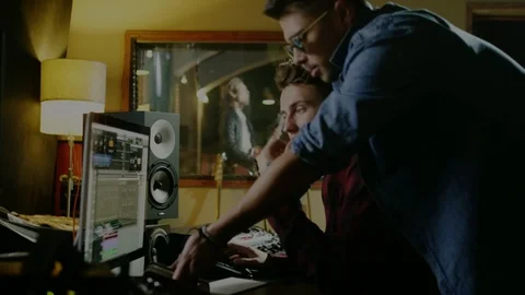 Sound engineers working in garage recording studio Stock Footage 100643252